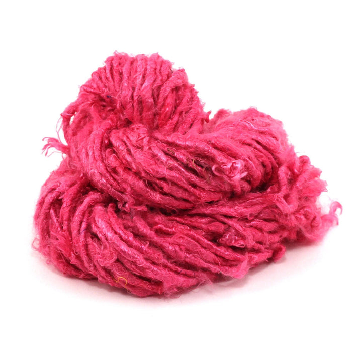 close up of yarn skein in the color rich magenta (pink)