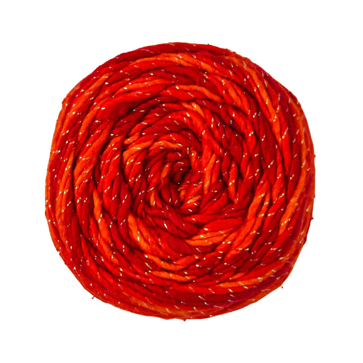 Sparkle worsted weight roving silk yarn in tonal red/orange colorway in front of a white background.
