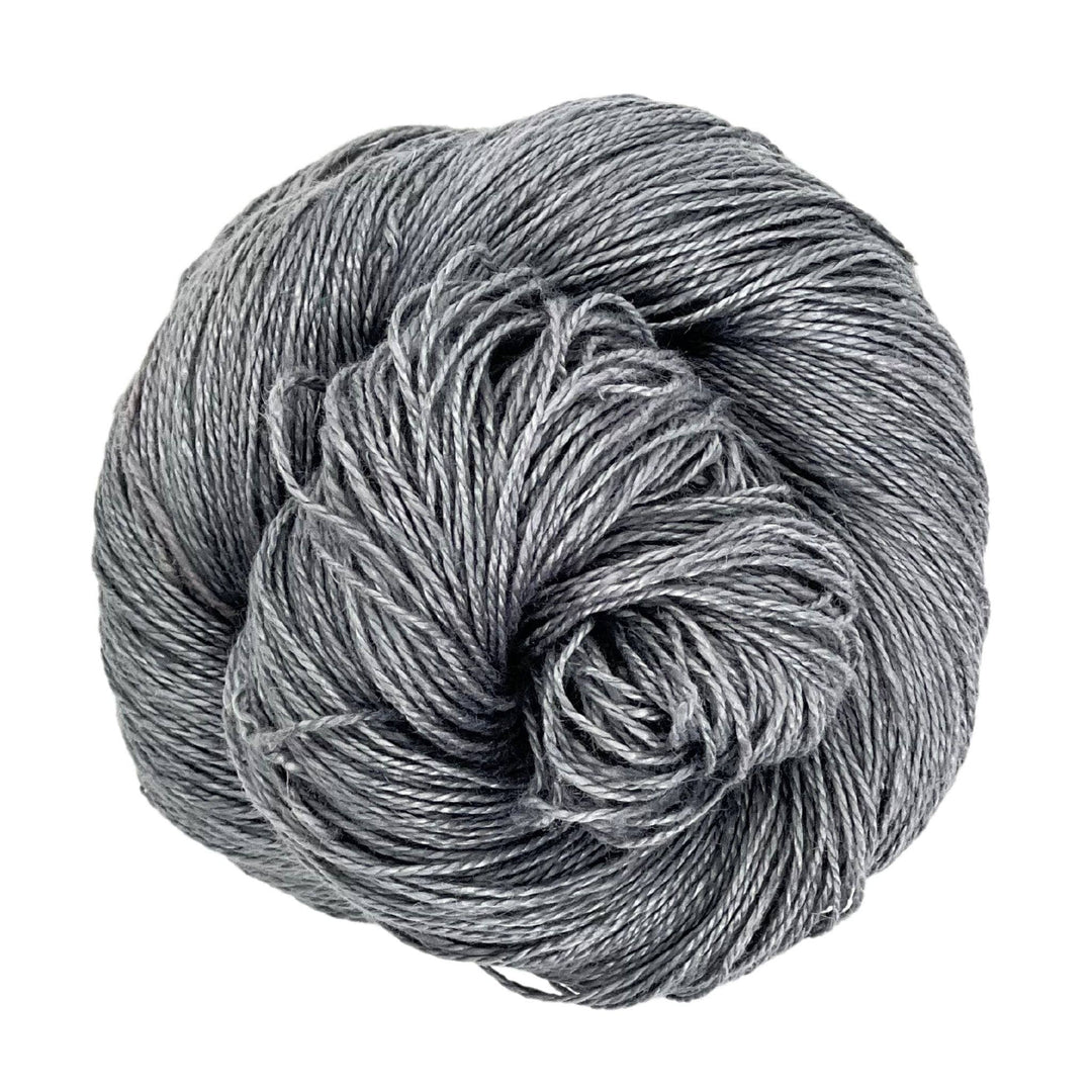 A skein of sport weight 2-Ply Linen Yarn in the colorway "Grey" on a white background.