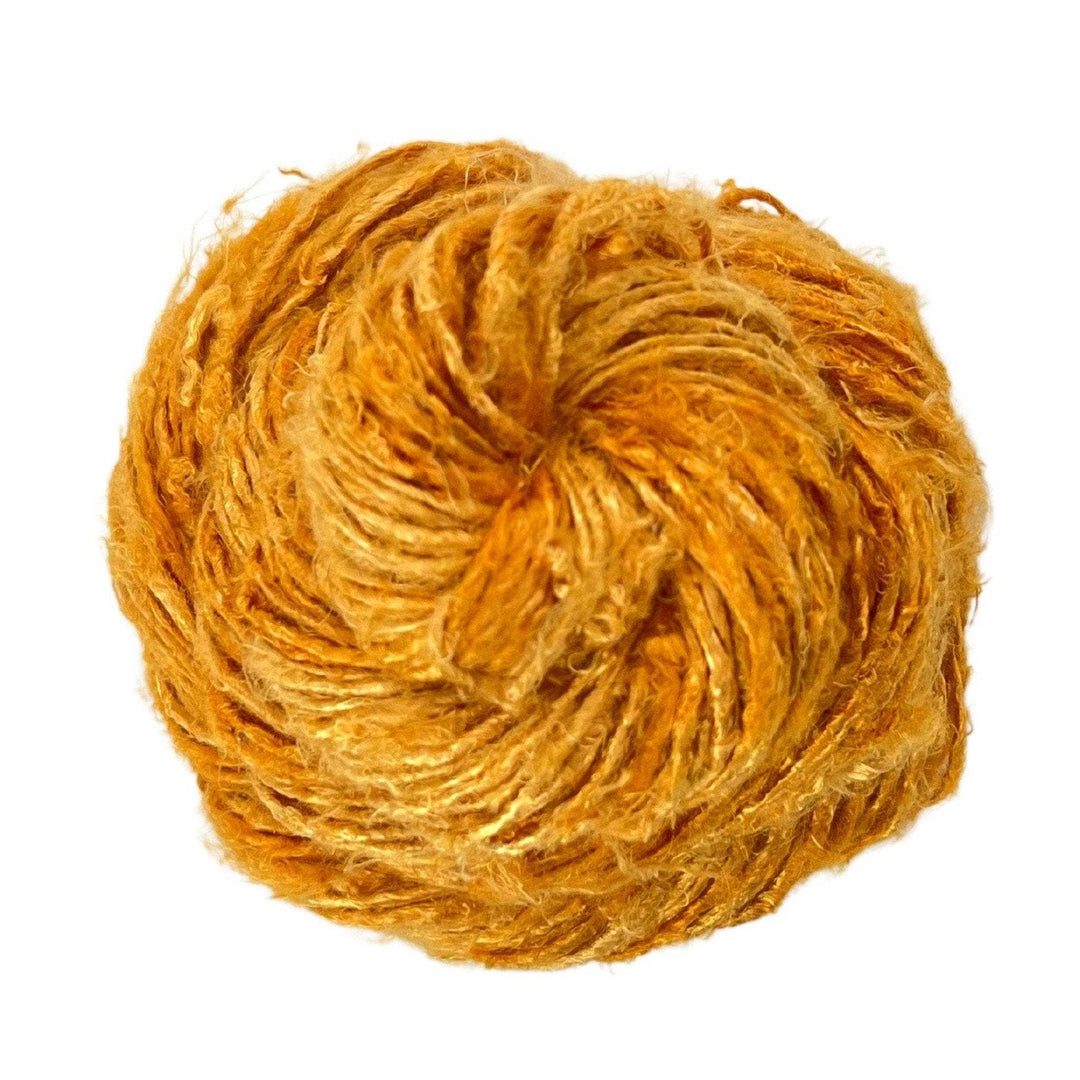 bright yellow banana fiber yarn in front of a white background.