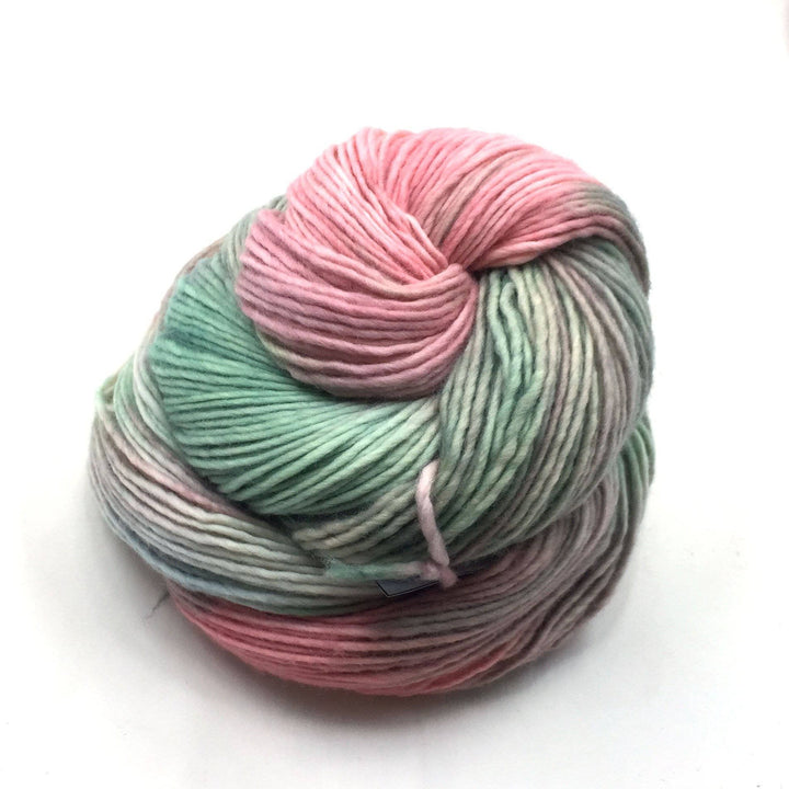 Worsted Weight Merino Wool Yarn donut ball in Yummy (pink, gray, green) on a white background