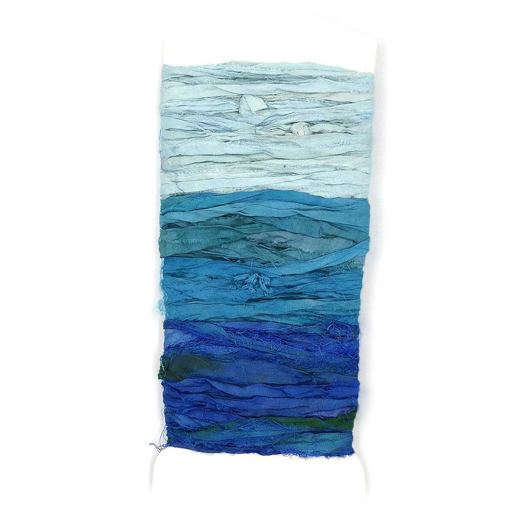 Sample Card of Sari Silk Ribbon yarn in Ocean Waves (blues) on a white background