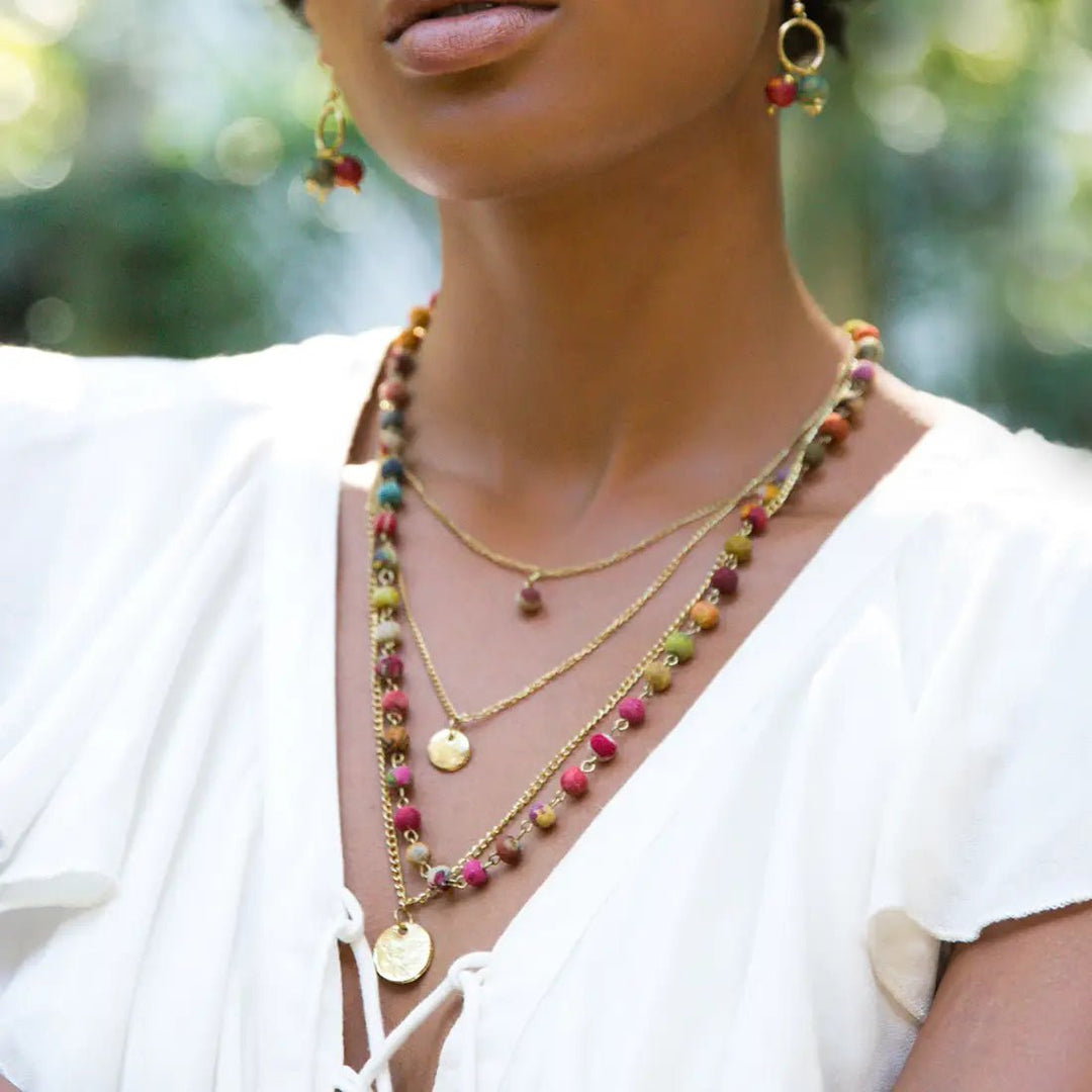 The Aasha necklace, made of sari beads. worn around a woman's neck.