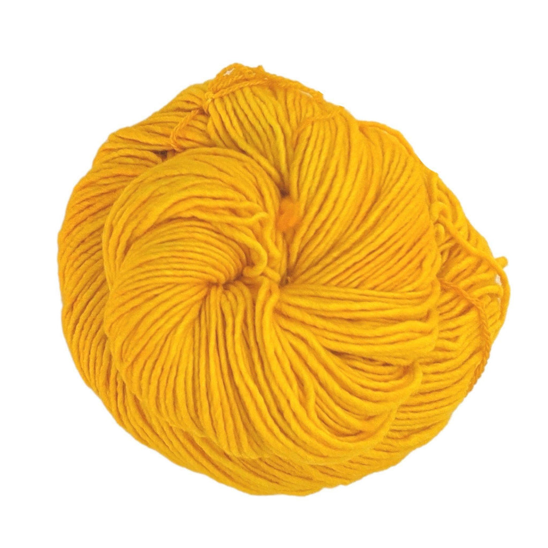 skein of single ply yellow malabrigo wool yarn in front of a white background.