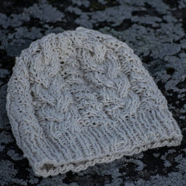 The Magnolia Beanie in Dandelion Poof (white) on a gray background