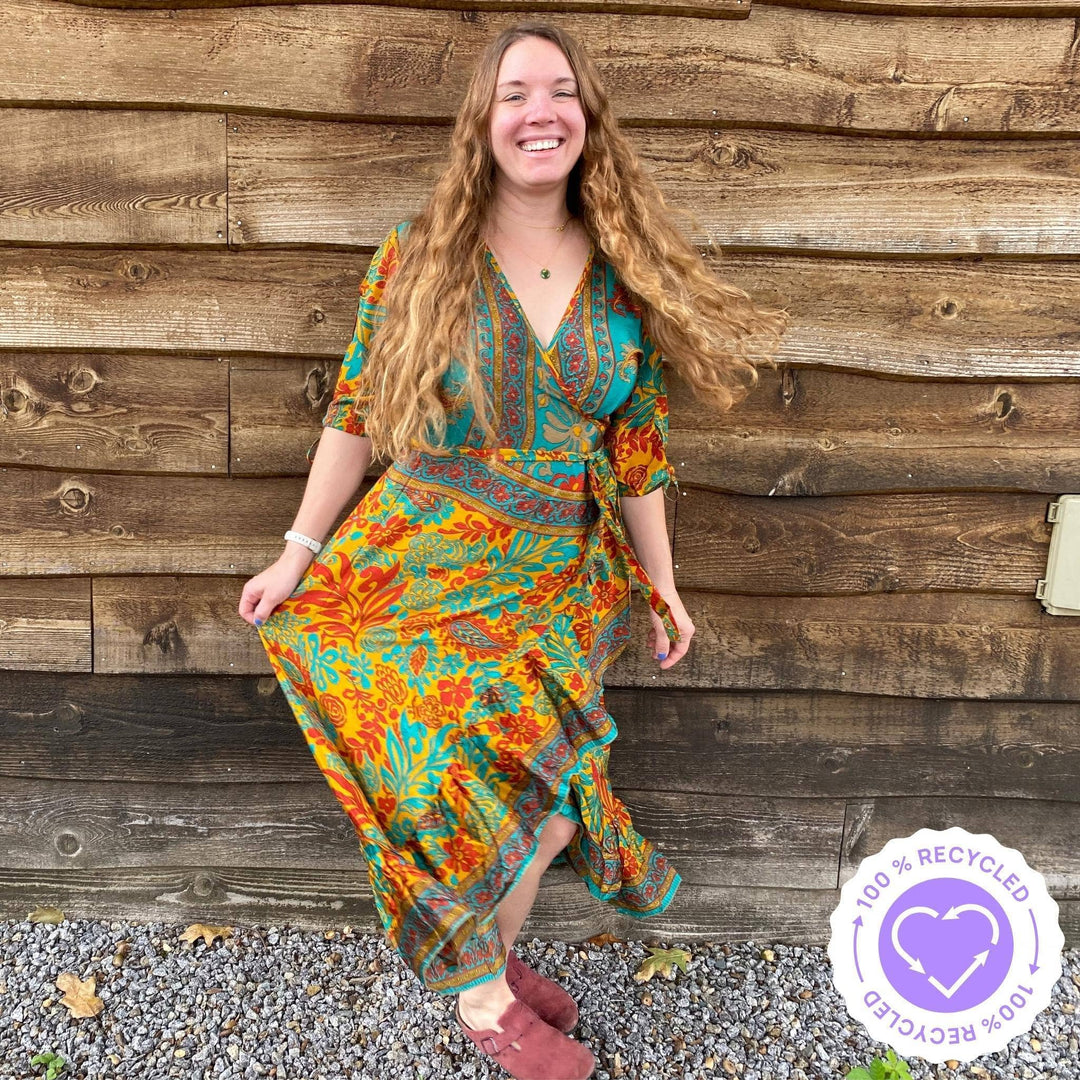 Nicole Snow wearing a warm tone Zaria Wrap Dress at a park