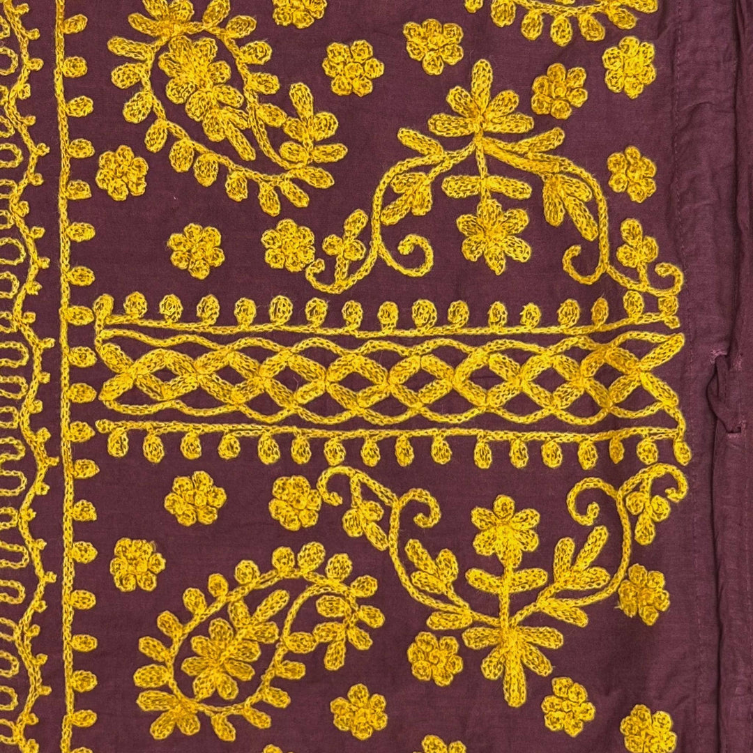Close-up of a brown/yellow  colorful embroidered kaftan.