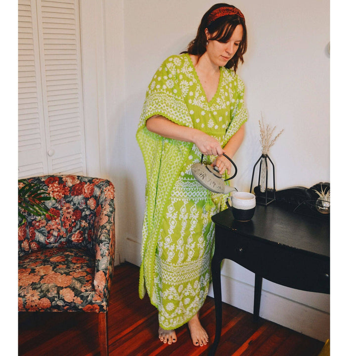 woman wearing green and white embroidered kaftan 