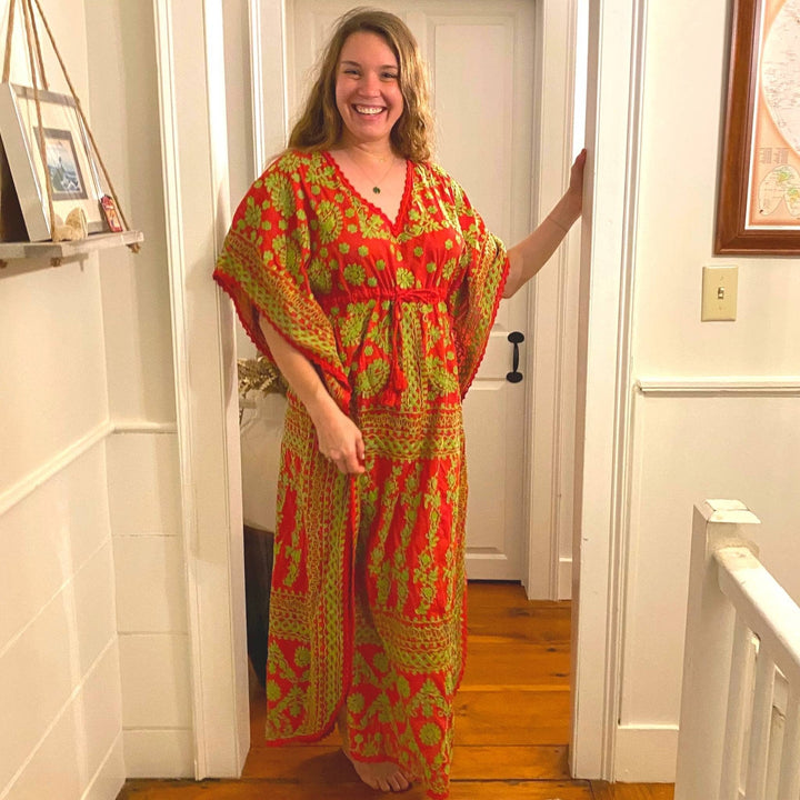 Nicole Snow wearing red and green embroidered kaftan nightgown.