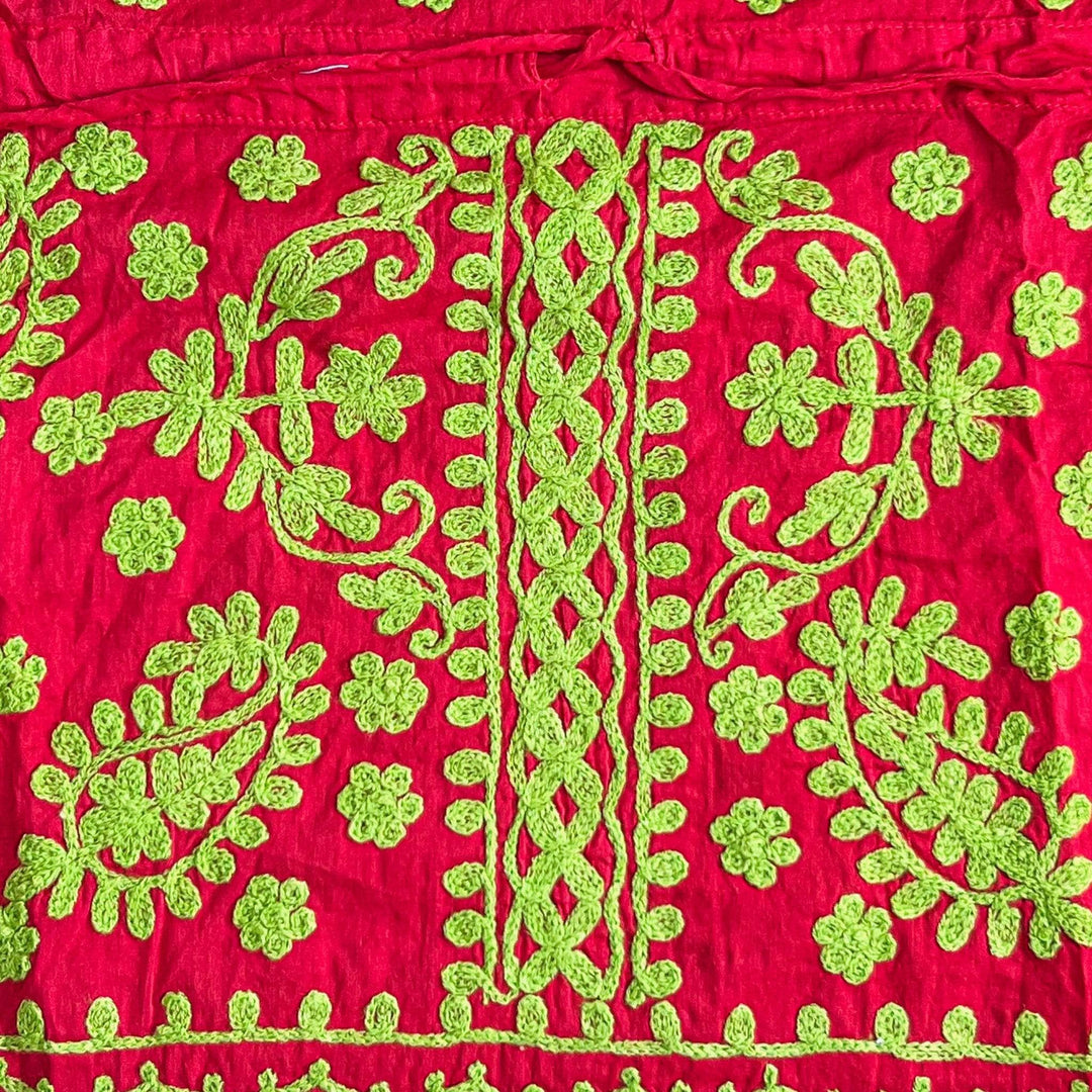Close-up of a red/green colorful embroidered kaftan.
