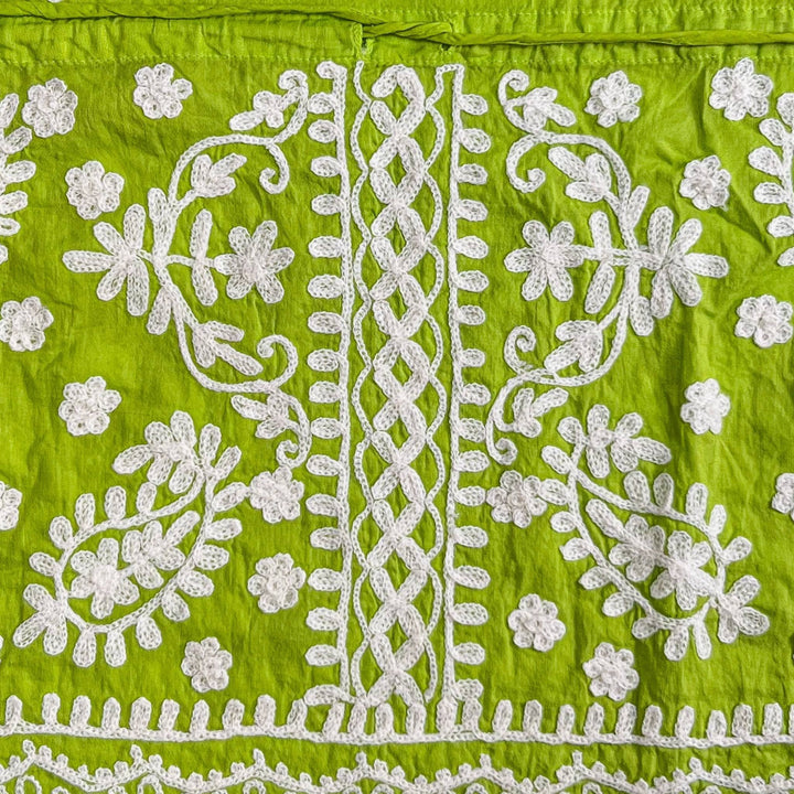 Close-up of a green/white colorful embroidered kaftan.