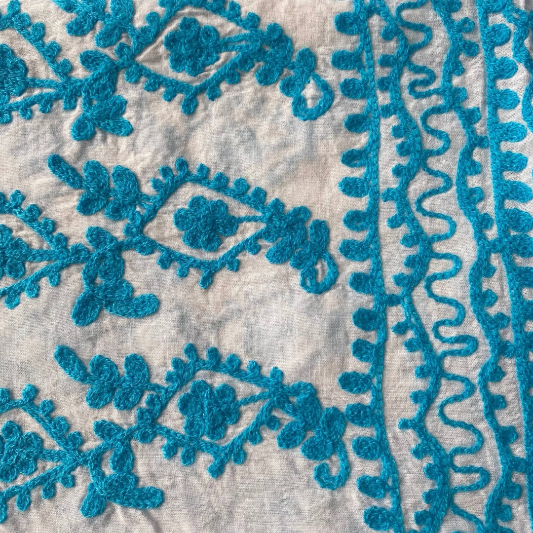 Close-up of a white/ blue classic embroidered kaftan.