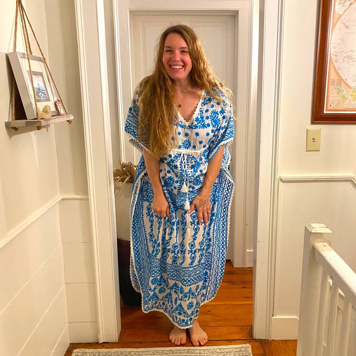 Nicole Snow wearing blue and white embroidered kaftan nightgown.