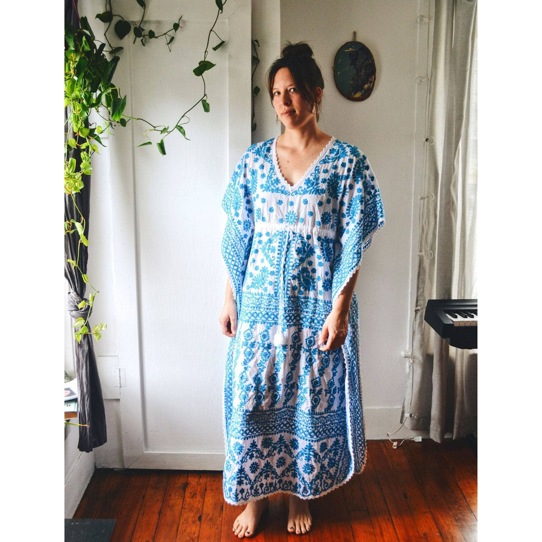 model wearing blue and white embroidered kaftan nightgown