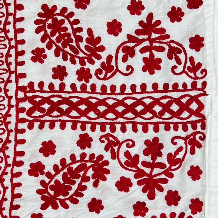 Close-up of a white/red classic embroidered kaftan.