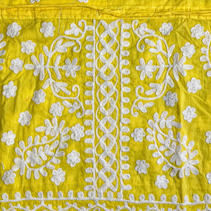 Close-up of a yellow/white colorful embroidered kaftan.