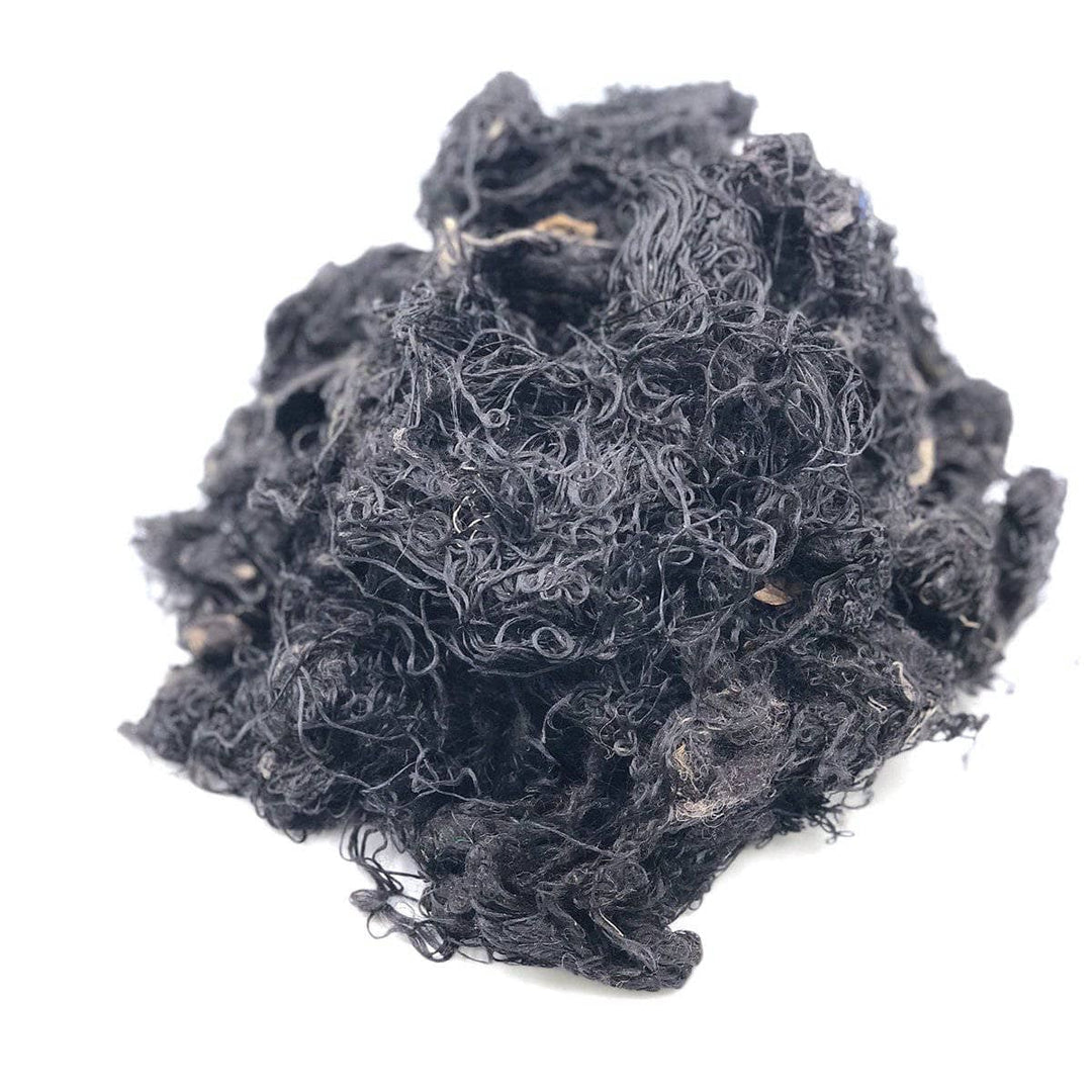 Black silk fibers on a white background