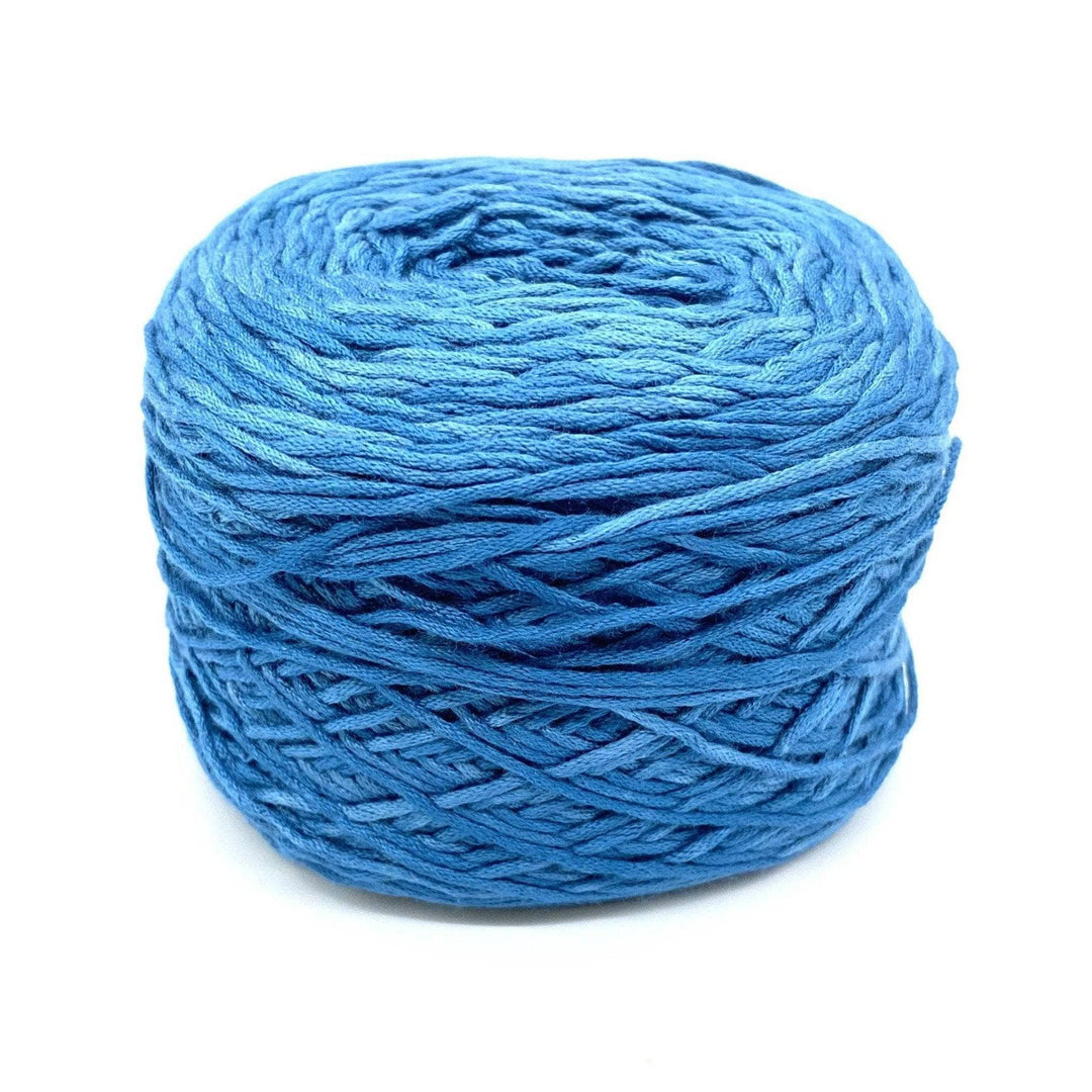 a cake of blue yarn on a white background