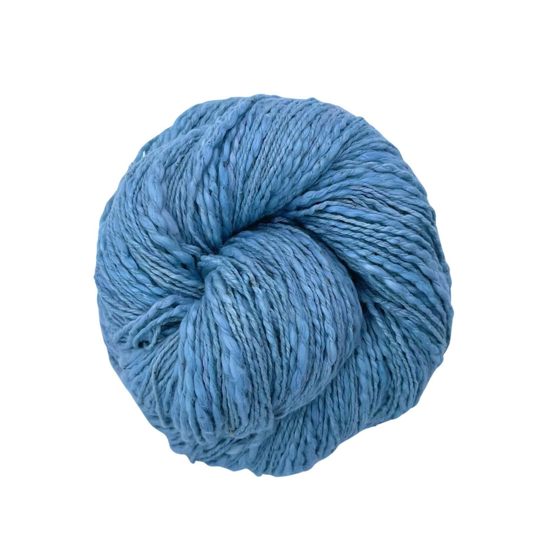 A skein of light blue cotton yarn on a white background