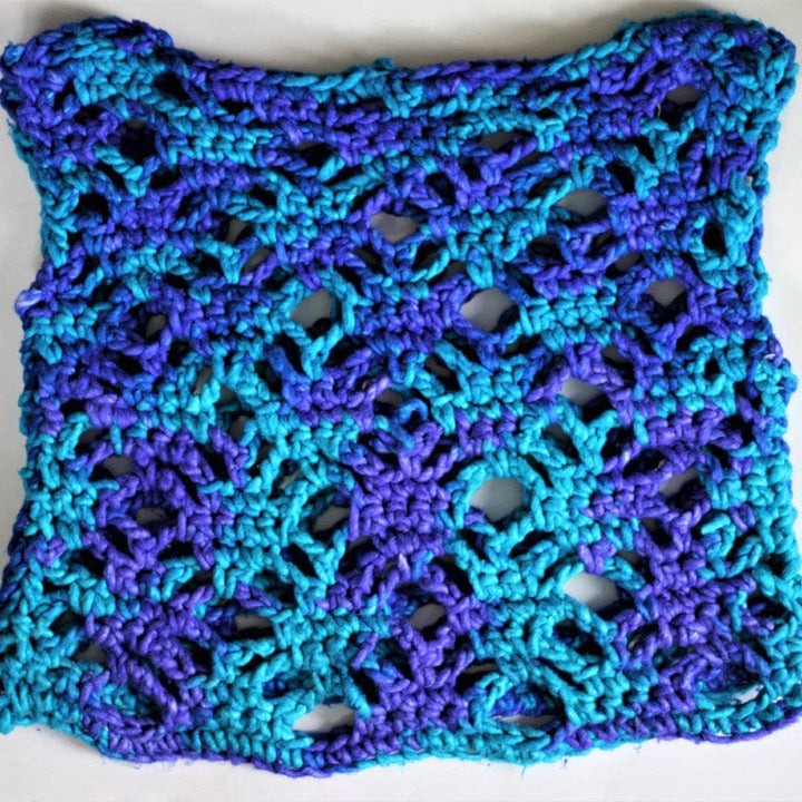 close up of a summer croche top in the colors blue and teal