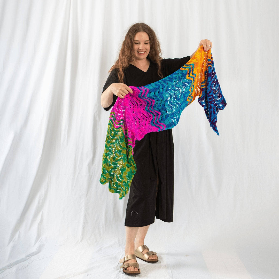 Founder Nicole holding wonderful waves crochet wrap in front of a white background.
