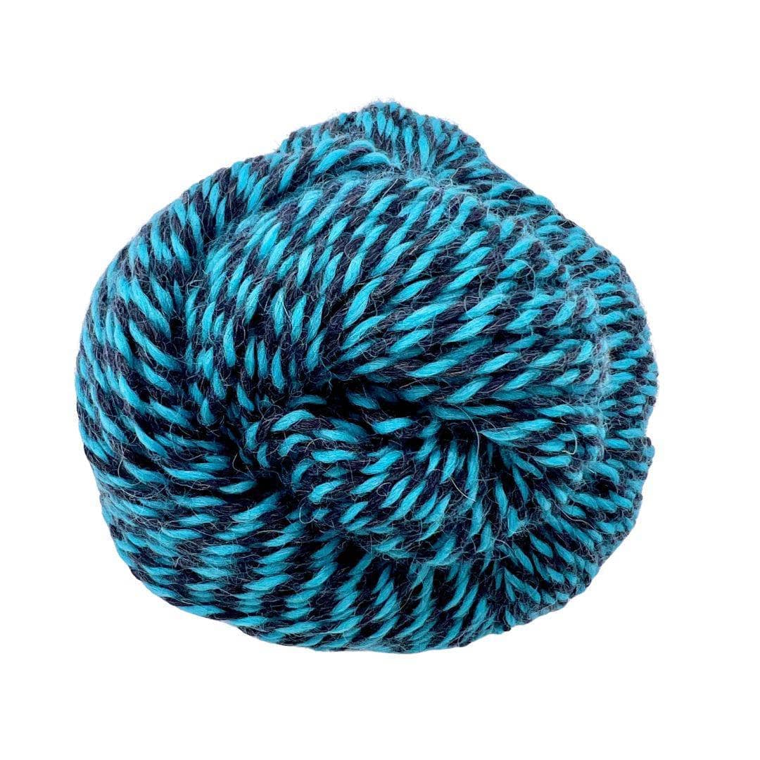 Blue and black twisted yarn on white background