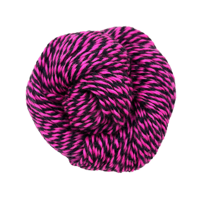 Pink and black twisted yarn on white background