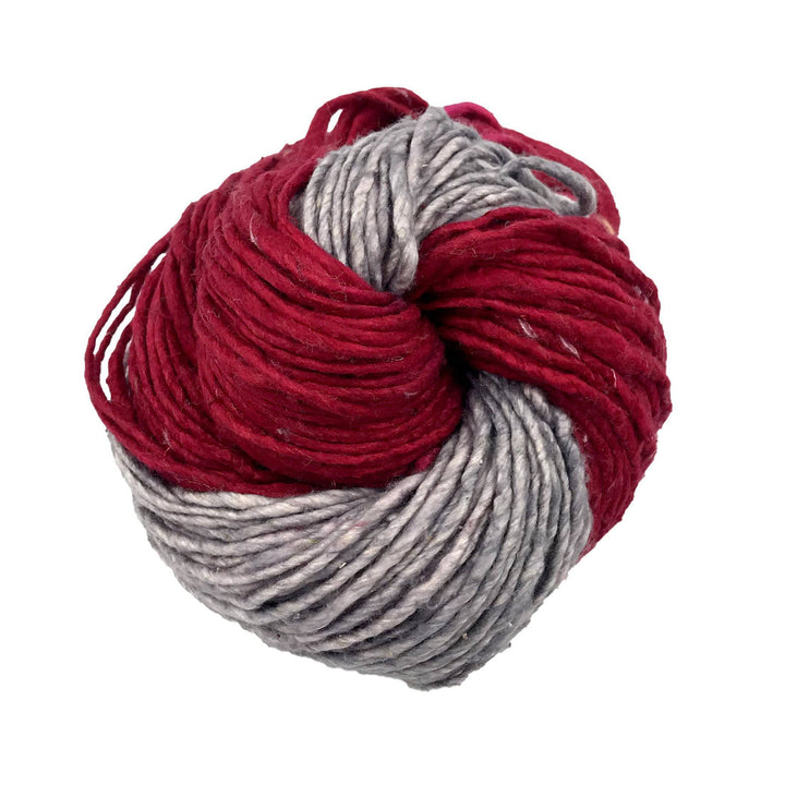 Silk roving worsted weight yarn in crimson fire in front of a white background.