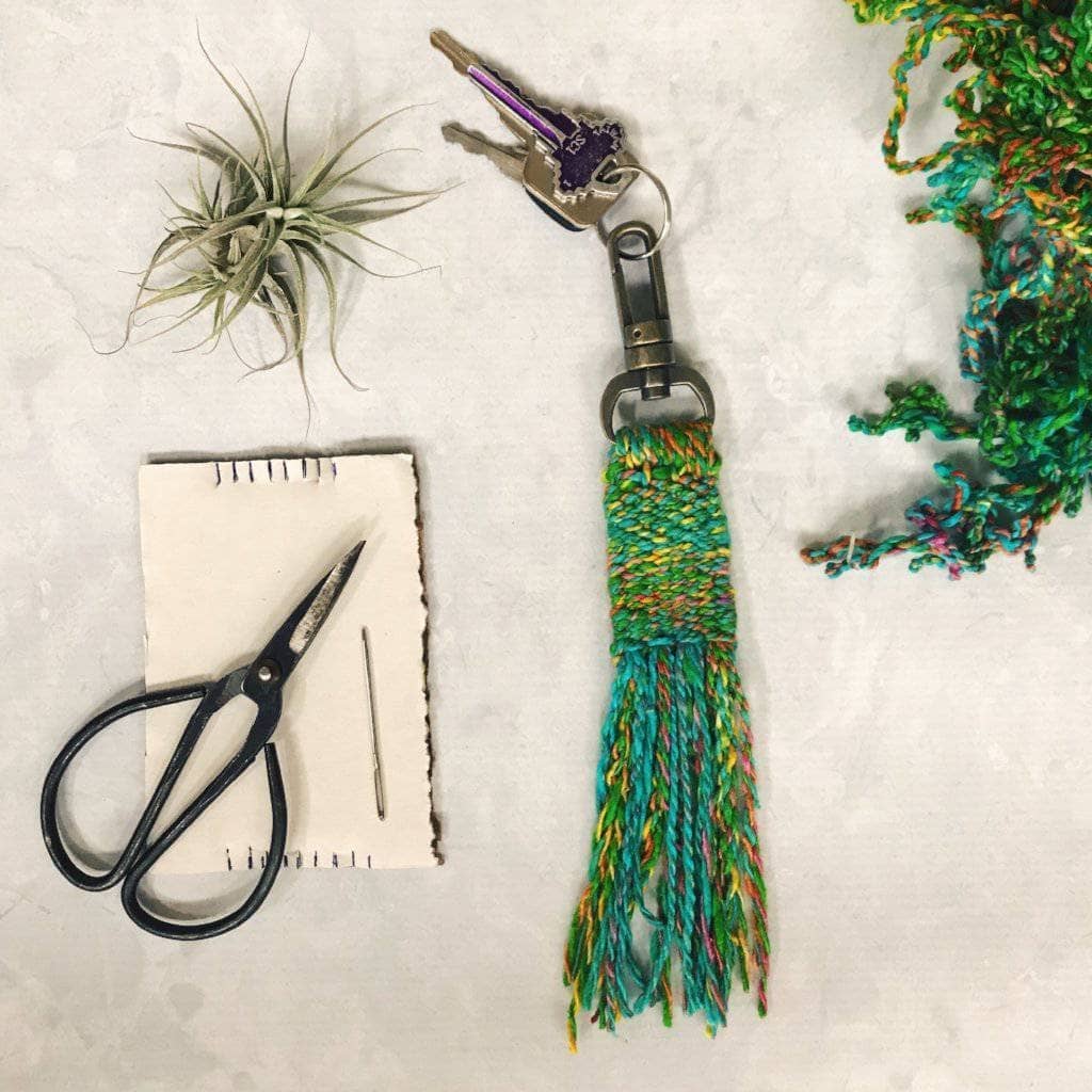 Kits - Woven Tassel Keychain with Key set, scissors, a plant, and yarn skein on a white background