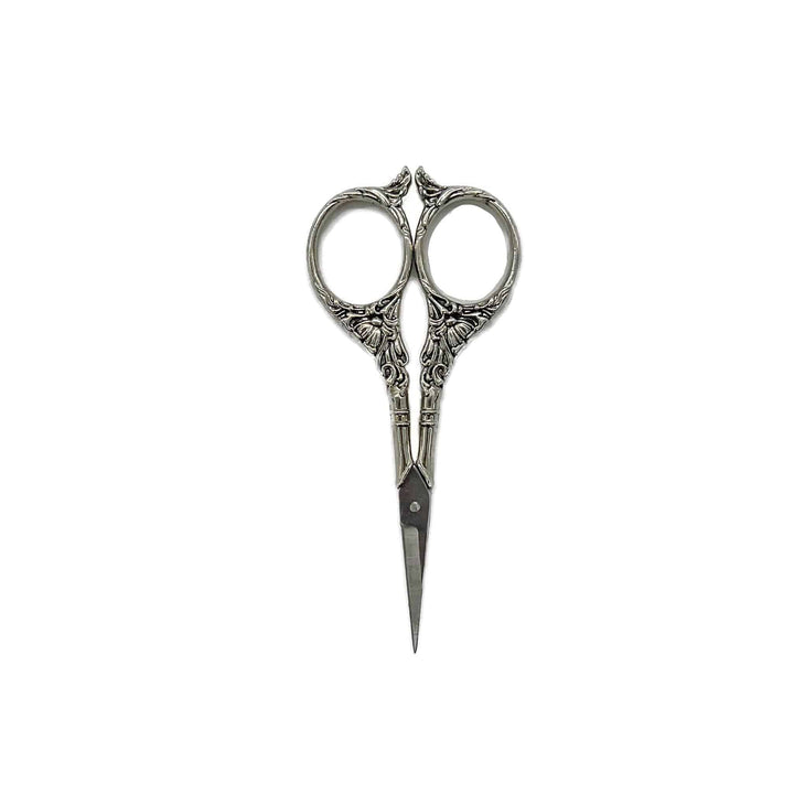 Silver craft scissors with a wavy design throughout the handles.
