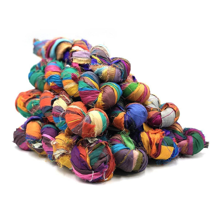 Bulk Yarn 10 pack bundle of Sari Silk Ribbon Chunky Yarn in "At the Bahamas", a blend of tropical greens, blues, oranges, yellows, and pinks.