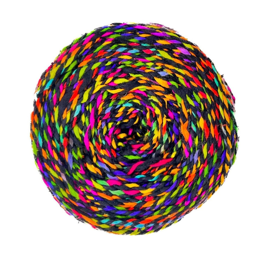 Skein of darn good twist sport weight silk in the colorway black rainbow in front of a white background. 2 ply recycled silk marled black and variegated rainbow.